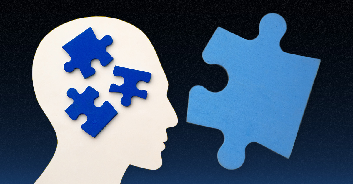 A profile silhouette of a head with three blue puzzle pieces inside and a larger blue puzzle piece outside on a dark gradient background. OCIDM,io Branding and Digital marketing Hamilton, Toronto, Oakville, Mississauga