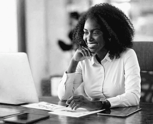 Person sitting at a desk, smiling at a laptop, with papers and a tablet nearby. OCIDM,io Branding and Digital marketing Hamilton, Toronto, Oakville, Mississauga Person sitting at a desk, smiling at a laptop, with papers and a tablet nearby. OCIDM,io Branding and Digital marketing Hamilton, Toronto, Oakville, Mississauga